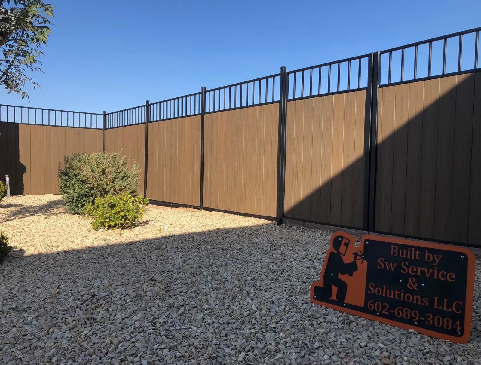 Steel-framed composite privacy fence with a view rail on top, Las Cruces